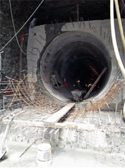To pour the concrete in the Strachan Avenue tunnel in Toronto, the formwork was de-moulded and then moved to the front end on rails—similar to a slip form system. Unlike the continuous pouring a true slip form system allows, each section was poured separately and allowed to harden before the formwork could be moved ahead for the next pour.