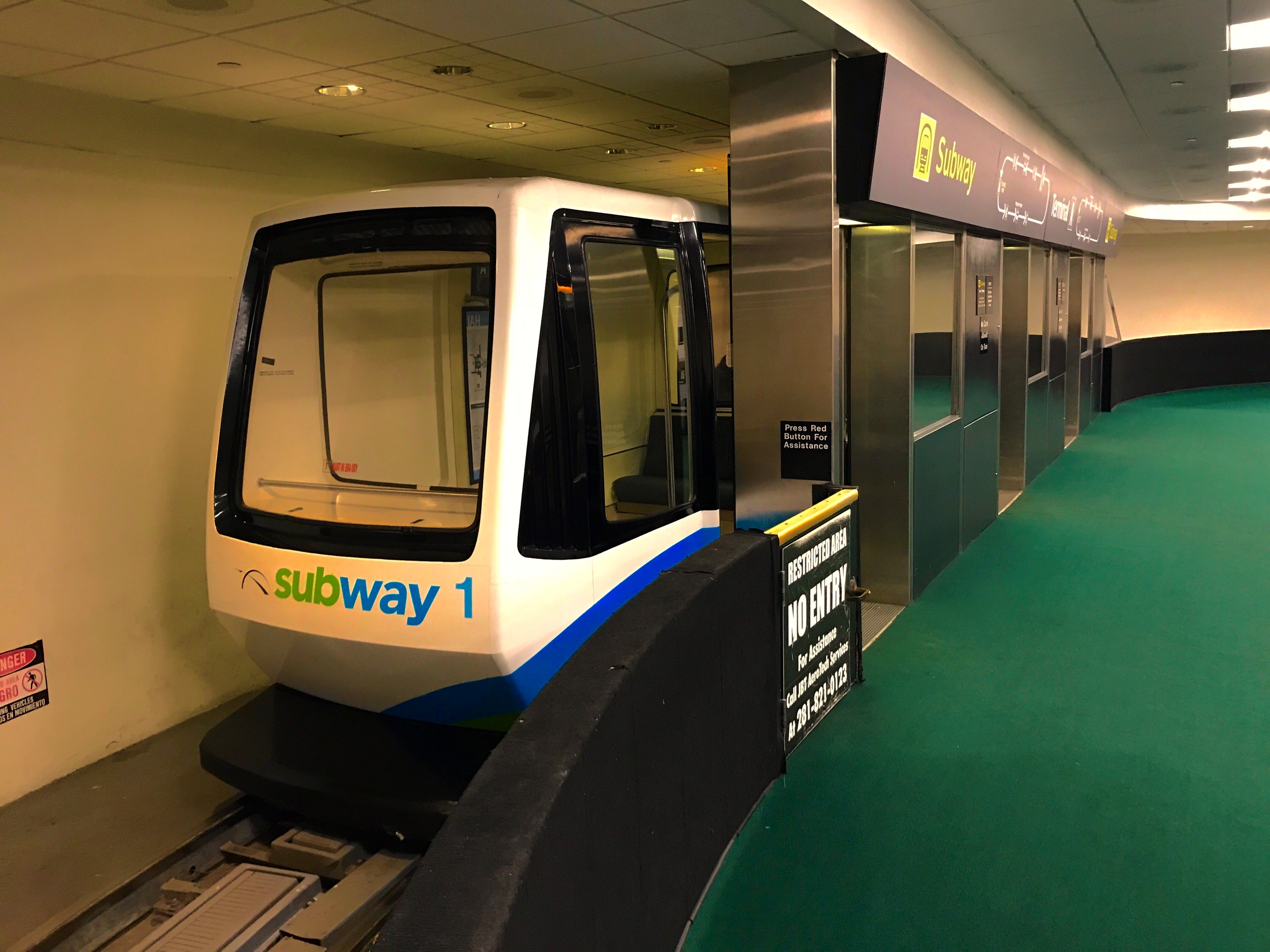 An ITT train for the George Bush Intercontinental Airport rests next to its station.